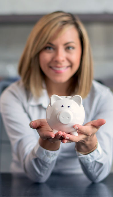 picture of woman holding a white piggy bank